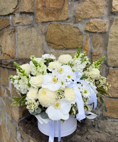 Pure Bliss white flower hatbox arrangement with roses and seasonal blooms.