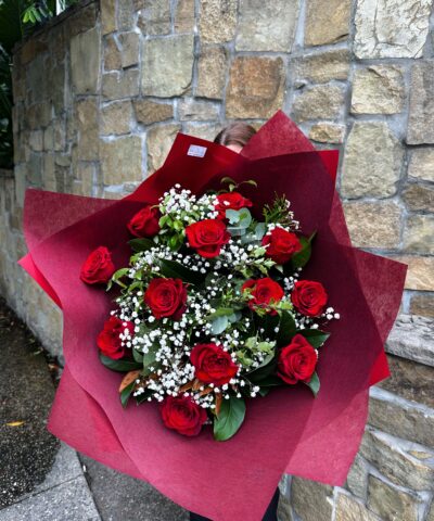 Everlasting Love dozen red roses bouquet with baby’s breath and foliage, wrapped in deep red paper by Brisbane florist The Lush Lily