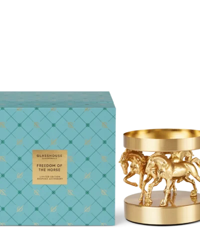 Glasshouse Freedom of the Horse limited edition gold candle holder with horse design beside blue patterned gift box.