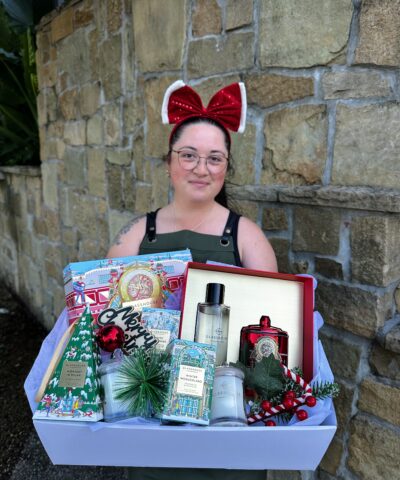 Glasshouse Christmas Wonderland Hamper featuring festive candles, room spray, mini candle and Christmas décor, held by a Lush Lily florist.