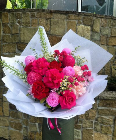 Garden Glam Bouquet featuring pink and red roses with seasonal blooms in luxury garden style arrangement Brisbane florist