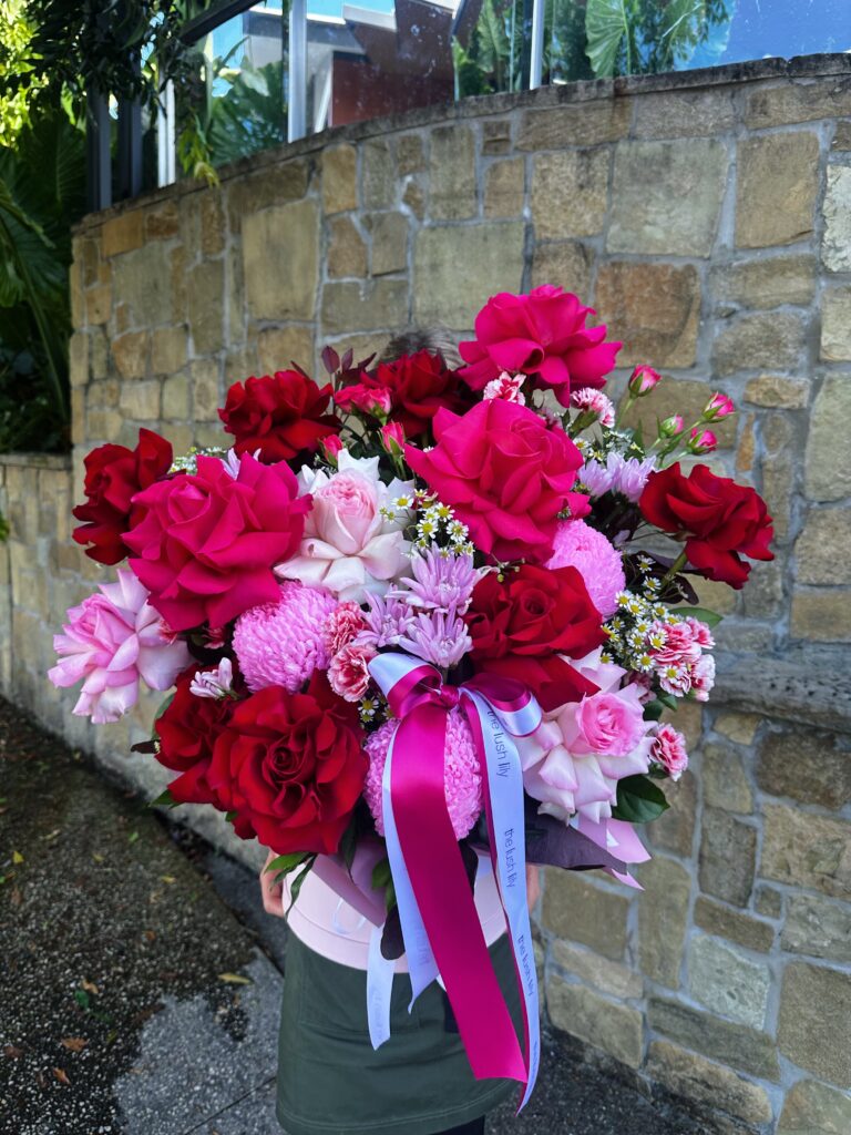 Cupid’s Signature luxury rose hatbox featuring red, blush and hot pink flowers by The Lush Lily Brisbane florist