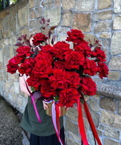 Luxury red rose arrangement featuring premium long-stem red roses with cascading ribbons by The Lush Lily Brisbane florist.