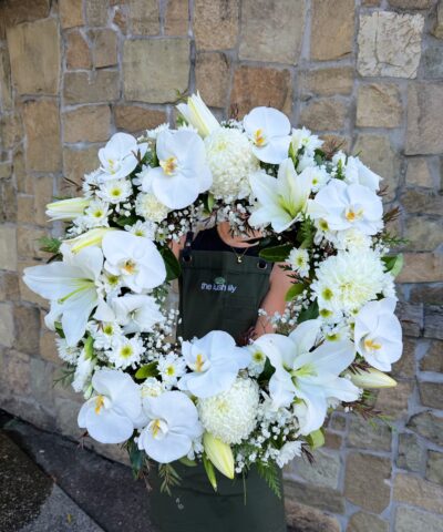 Ivory Embrace Wreath – elegant white sympathy wreath with orchids and lilies, funeral flowers Brisbane