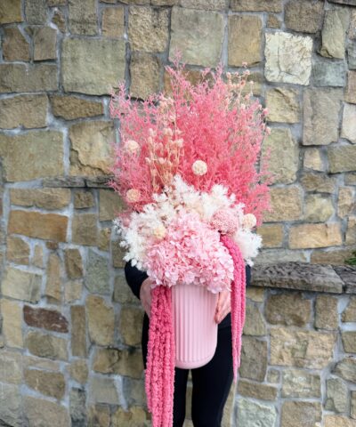 Pink Fizz dried and preserved flower arrangement with pink hydrangea, white textured flowers and cascading pink amaranthus in a ribbed pink vase.