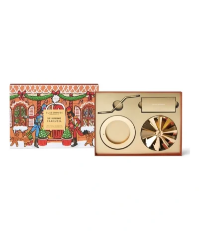 Glasshouse Fragrances Christmas Spinning Carousel candle accessory with gold carousel pieces and festive gift packaging